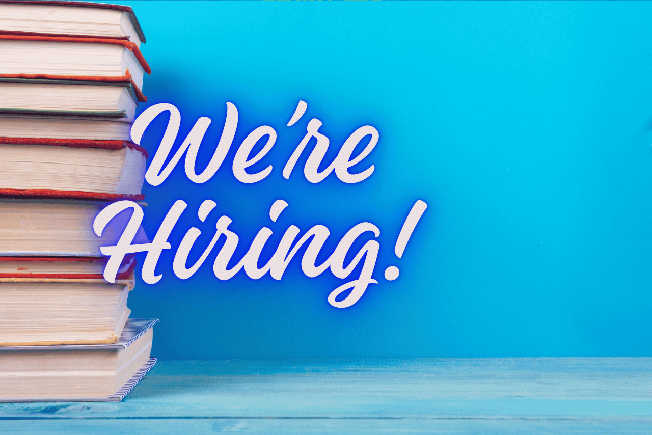 Stack of books with the words "We're Hiring!"